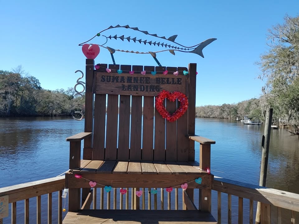 The Suwannee Belle Landing chair on the deck beside the Suwannee River
